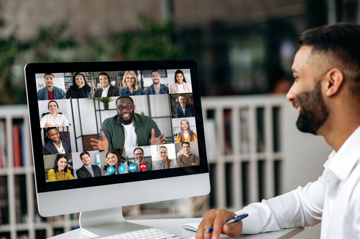 Online conversation by video conference. Successful Indian business man has a virtual meeting with multiracial business colleagues, discussing financial strategy, talking on a video call,brainstorming